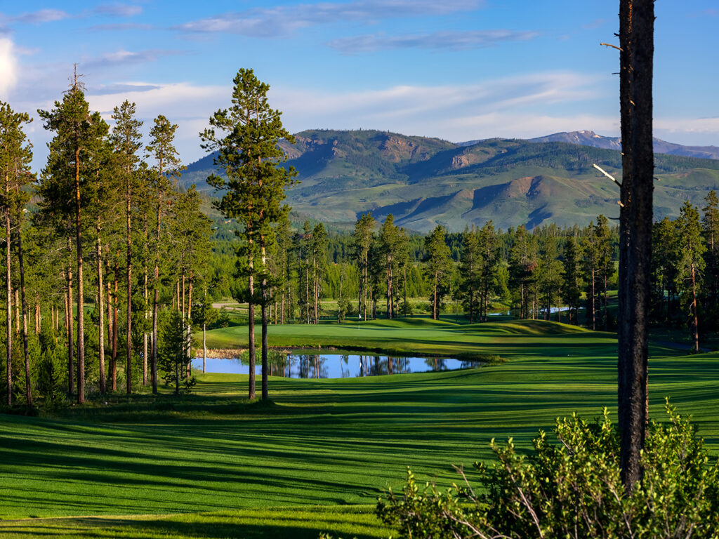 A stunning morning view at Pole Creek, where meticulously groomed fairways are lined with tall pine trees. 